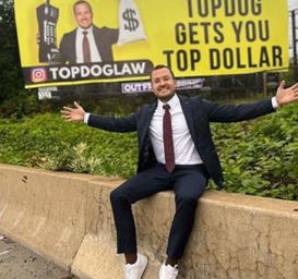 Wrongful Death Lawyer James Helm cheering in front of TopDog Billboard
