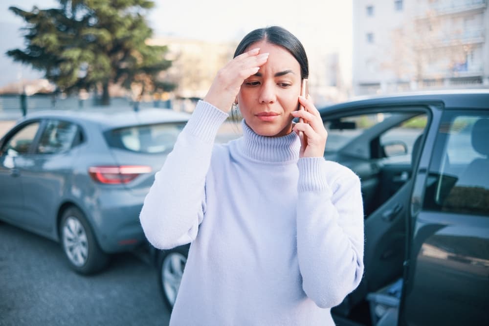 Woman calling rideshare accident lawyer after a car accident in Bronx.